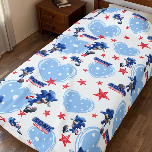 Sonic Blanket in the Blue Hearts and Stars design, on a kids bed