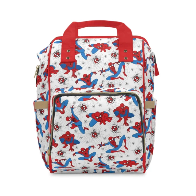 White Spider-Man diaper bag with red and blue Spidey poses on spider webs and red handles, the baby's name printed on the pocket.