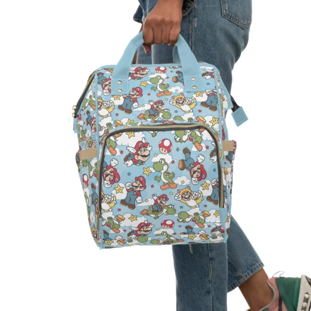 Mom wearing the light blue Super Mario diaper bag as a backpack for hands-free carrying.