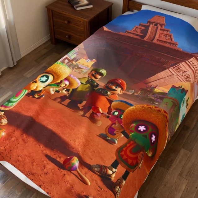 Super Mario Galaxy Blanket in the Desert Kingdom design, on a kids bed