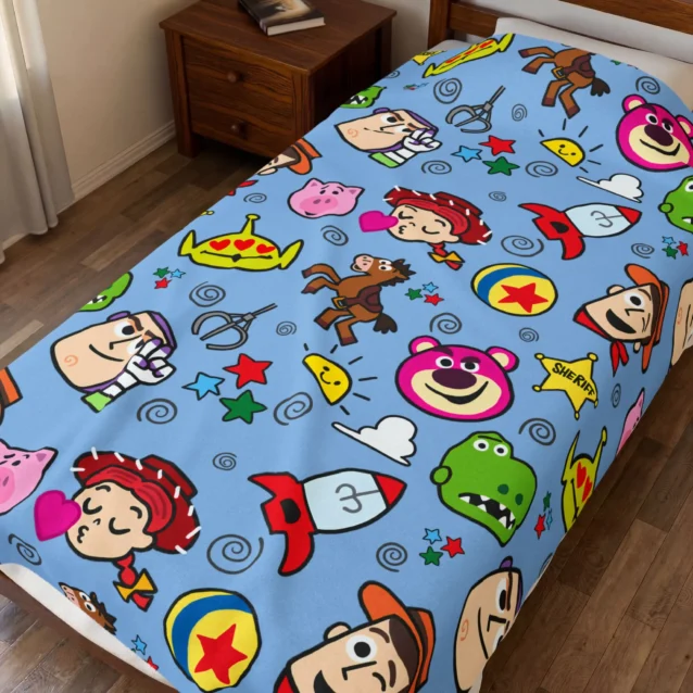 Toy Story throw blanket in the Blue Cartoon Doodle design, styled in a bedroom.