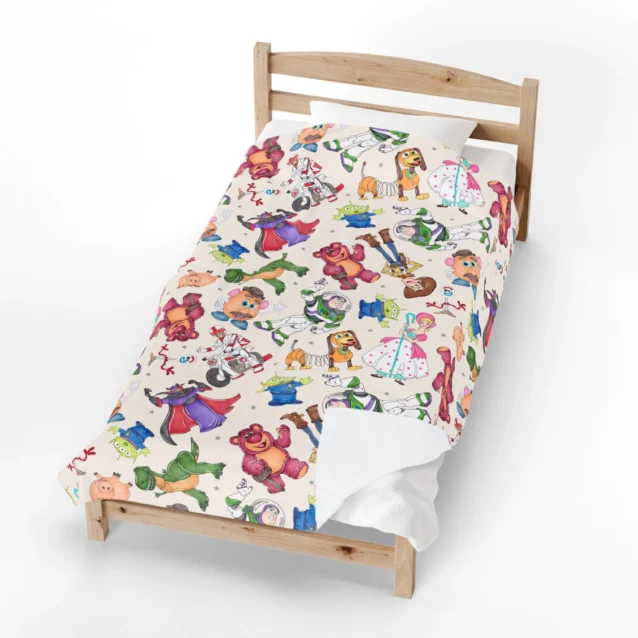 Toy Story fleece blanket in the Character Collage design, spread on a kids bed.