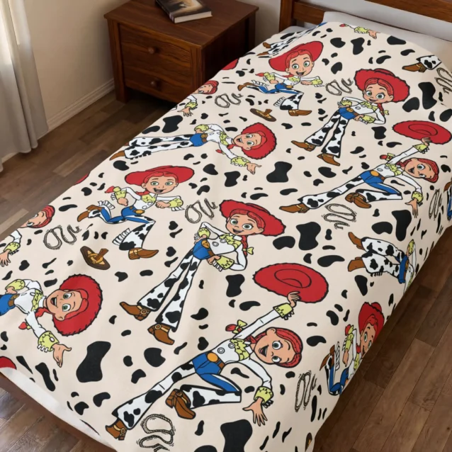 Toy Story throw blanket in the Jessie Cowgirl design, styled in a bedroom.